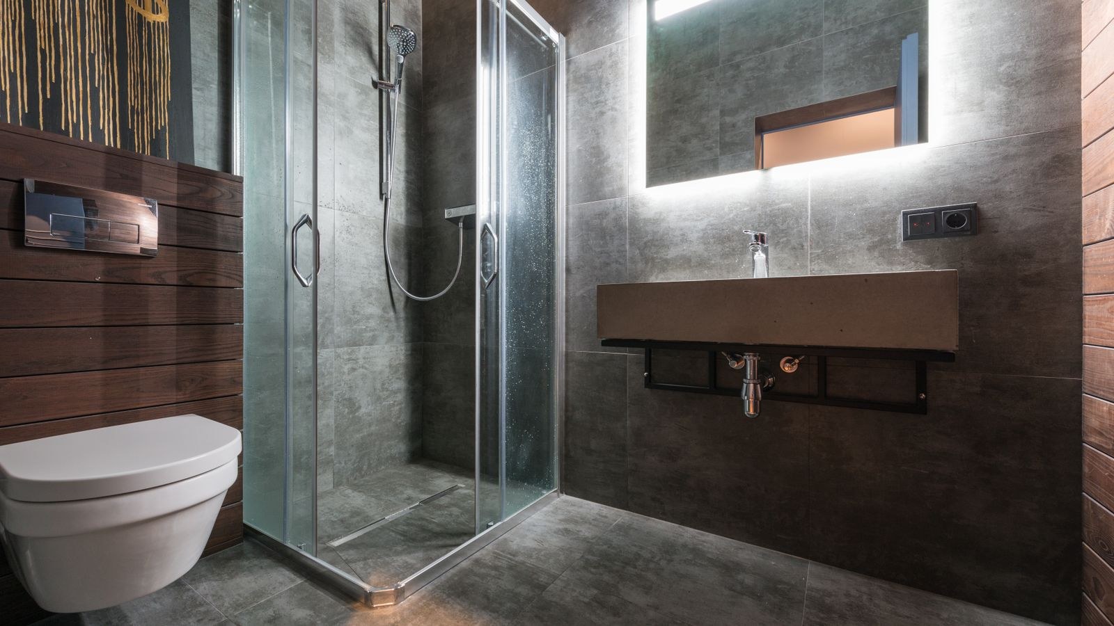 Modern bathroom with glass shower enclosure and wet rated ceiling lighting