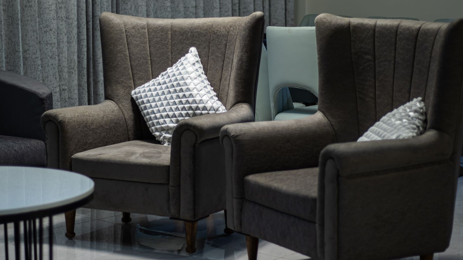 Low leather club chair with rolled arms in a den
